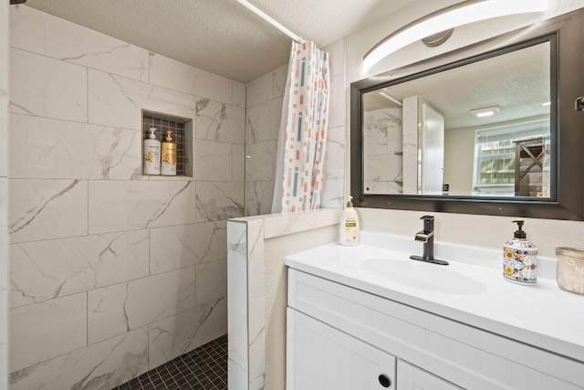 bathroom featuring walk in shower, a textured ceiling, and vanity