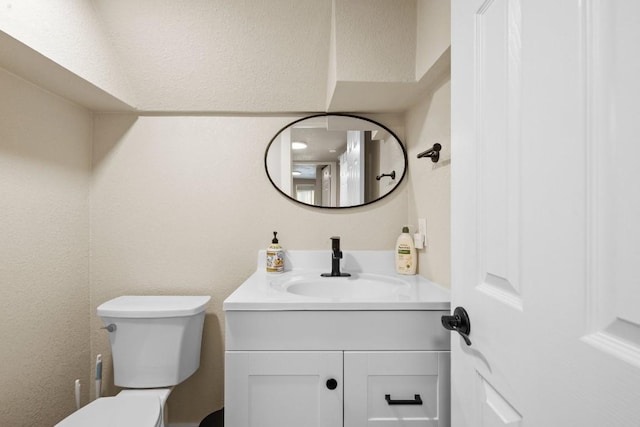 bathroom with toilet and vanity