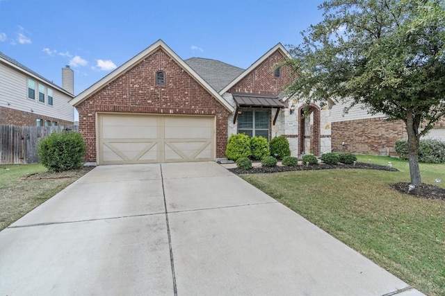 view of front of house with a front yard and a garage