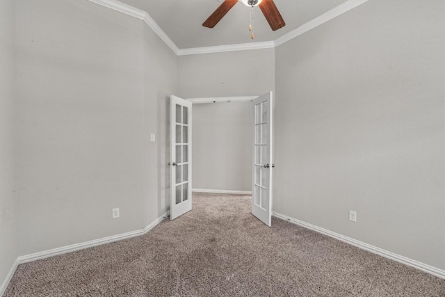 carpeted spare room with french doors, ceiling fan, and crown molding