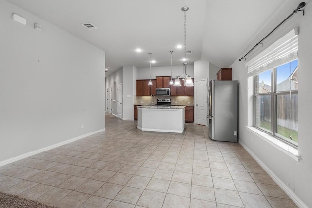 kitchen featuring plenty of natural light, a center island, hanging light fixtures, and appliances with stainless steel finishes