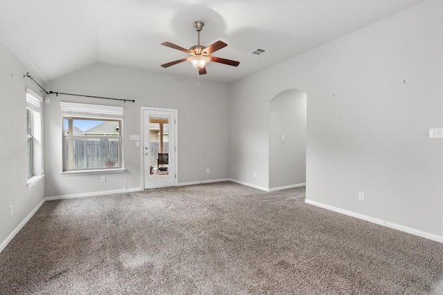 carpeted empty room with vaulted ceiling and ceiling fan