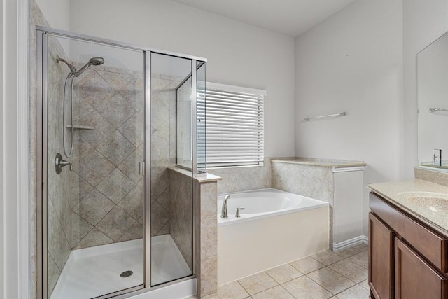 bathroom featuring tile patterned floors, vanity, and shower with separate bathtub