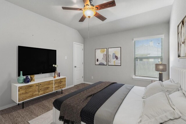 carpeted bedroom featuring ceiling fan and vaulted ceiling