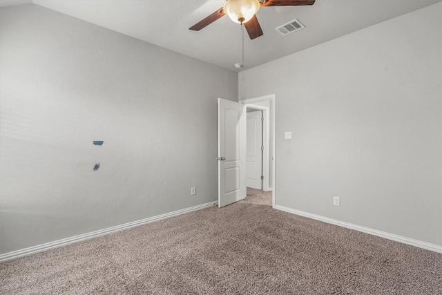 empty room featuring carpet flooring, vaulted ceiling, and ceiling fan