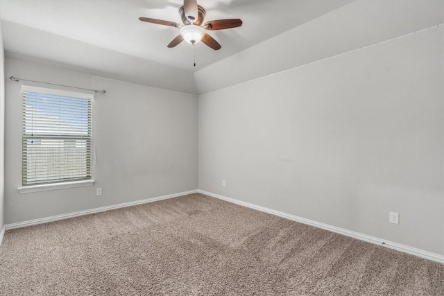 spare room with ceiling fan, carpet, and vaulted ceiling