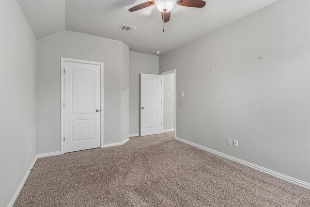 unfurnished bedroom with ceiling fan, carpet, and lofted ceiling