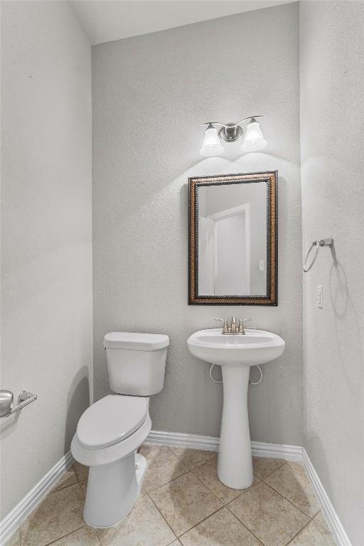 bathroom featuring tile patterned flooring and toilet