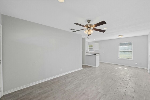 307 E Powell Ln, Austin, TX 78753 - unfurnished living room with ceiling fan and light hardwood / wood-style flooring