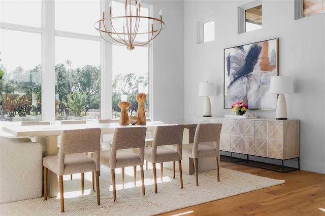 17216 Morning Grove Ln, Austin, TX 78738 - dining space with wood finished floors, a chandelier, and a high ceiling