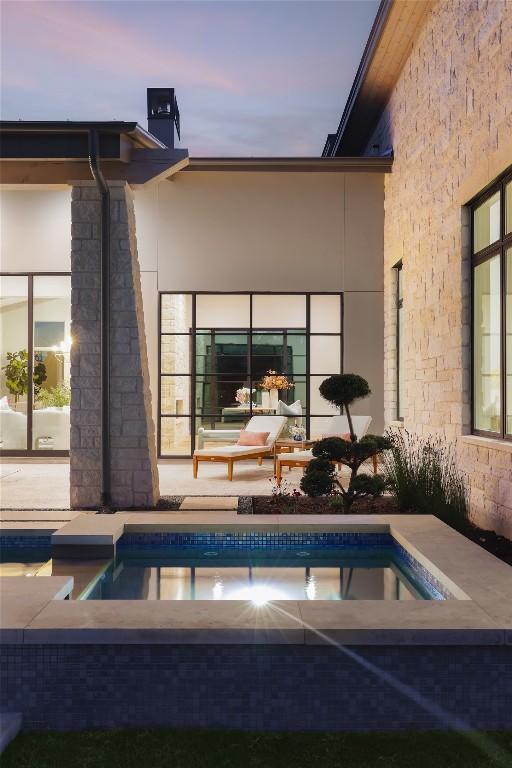17216 Morning Grove Ln, Austin, TX 78738 - pool at dusk featuring an outdoor pool