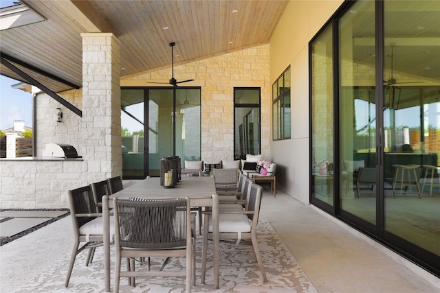 view of patio / terrace featuring exterior kitchen, outdoor dining space, and a ceiling fan