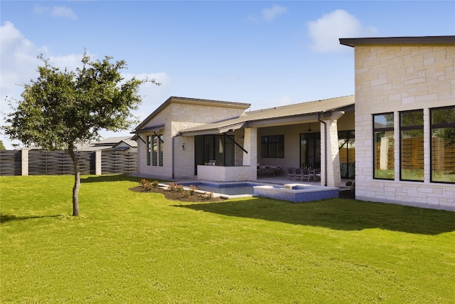 rear view of house featuring a patio area, a fenced backyard, a lawn, and metal roof