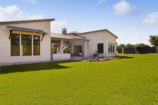 17216 Morning Grove Ln, Austin, TX 78738 - back of house featuring a standing seam roof, a lawn, metal roof, a chimney, and a patio