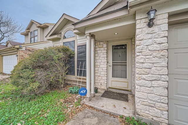 doorway to property with a garage