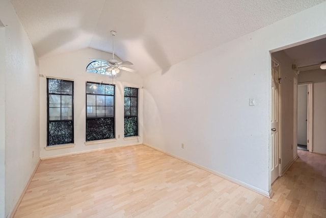 empty room featuring ceiling fan, light hardwood / wood-style flooring, and vaulted ceiling