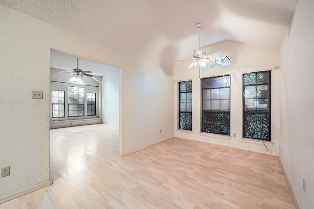 interior space with ceiling fan, light wood-type flooring, and lofted ceiling