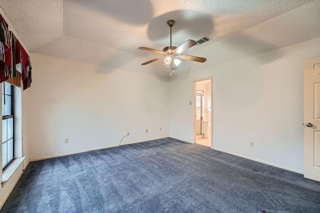 carpeted spare room with ceiling fan, a raised ceiling, lofted ceiling, and a textured ceiling