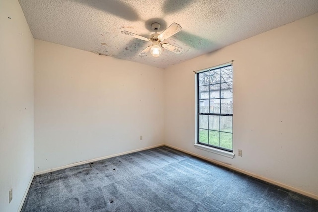 empty room with carpet flooring, ceiling fan, and a textured ceiling