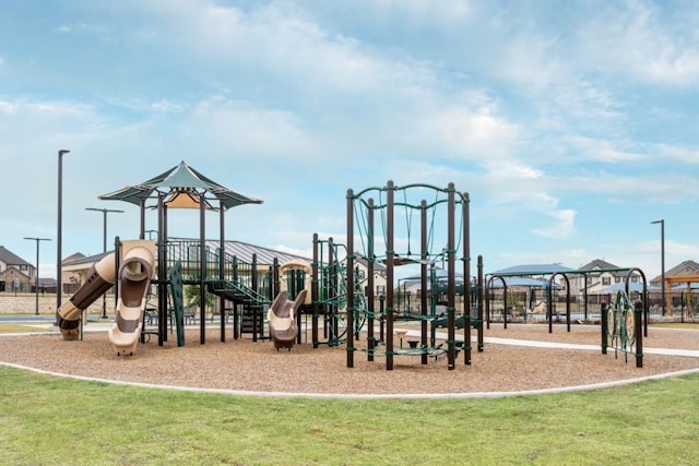 view of jungle gym featuring a lawn