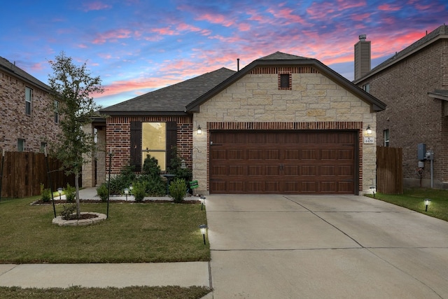 view of front of home with a lawn and a garage