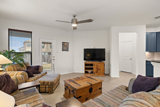 living room with ceiling fan and light tile patterned floors