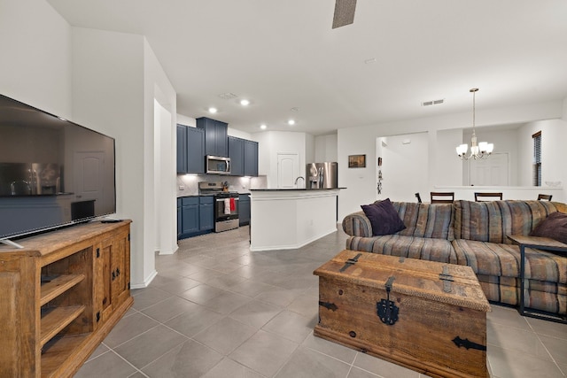 4429 Venticano Pl, Round Rock, TX 78665 - living room with tile patterned floors, a chandelier, and recessed lighting