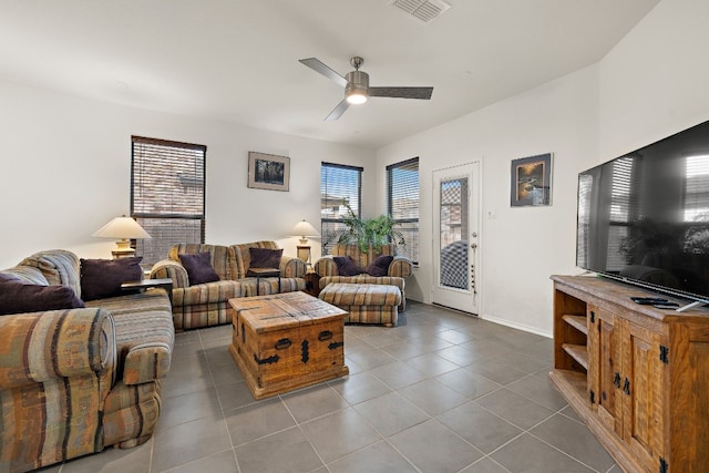 tiled living room with ceiling fan