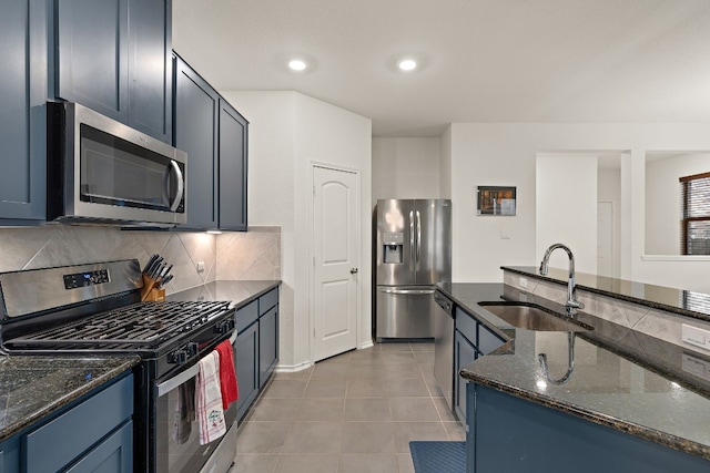 4429 Venticano Pl, Round Rock, TX 78665 - kitchen featuring appliances with stainless steel finishes, dark stone countertops, decorative backsplash, light tile patterned floors, and recessed lighting