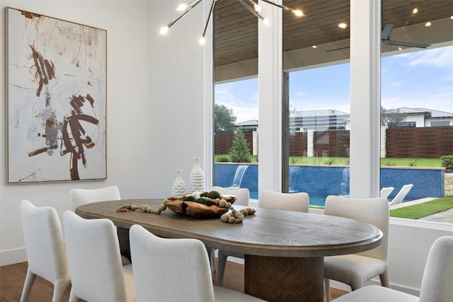 dining space with hardwood / wood-style flooring and an inviting chandelier