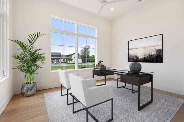 home office with ceiling fan and light hardwood / wood-style floors