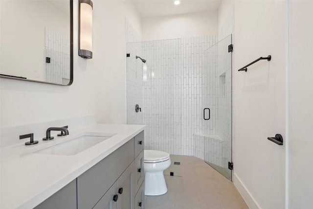 bathroom featuring a stall shower, vanity, toilet, and tile patterned floors