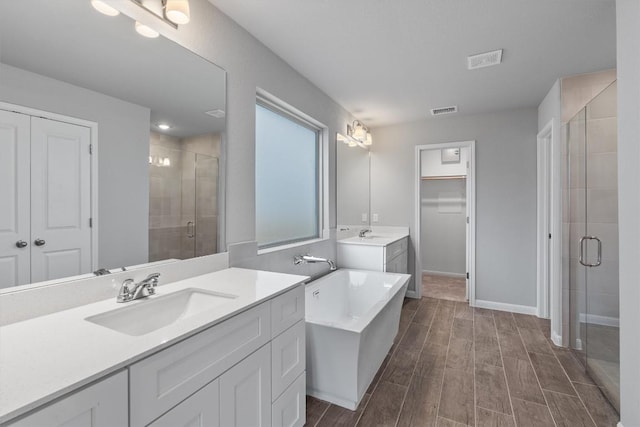 bathroom with vanity and a shower with shower door