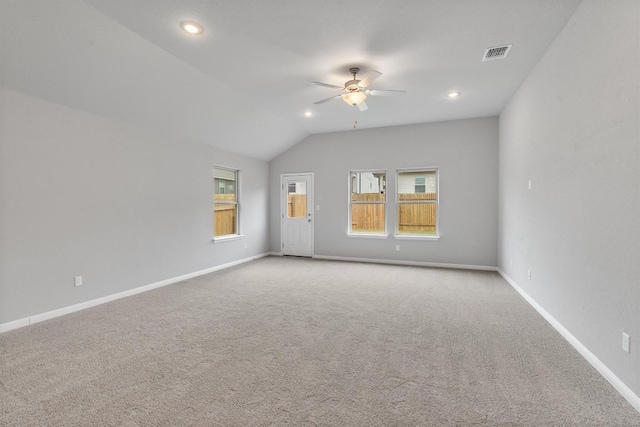 carpeted empty room with ceiling fan and vaulted ceiling