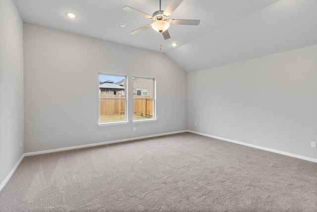 unfurnished room featuring ceiling fan, lofted ceiling, and carpet floors