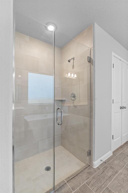 bathroom with a shower with shower door