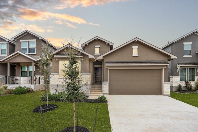 craftsman-style home with a garage and a yard