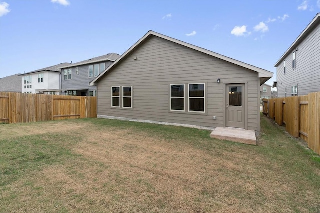 rear view of house with a lawn