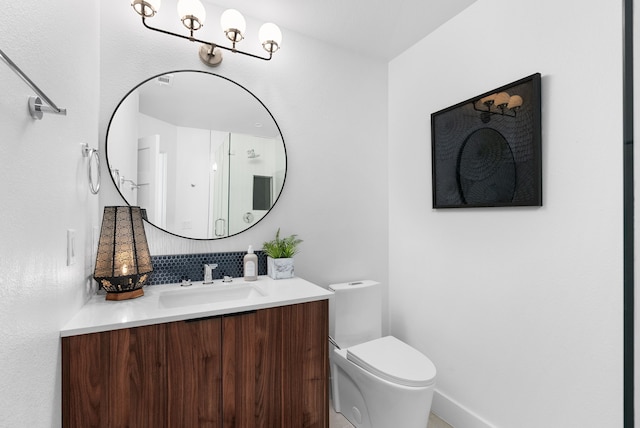 bathroom featuring decorative backsplash, toilet, and vanity