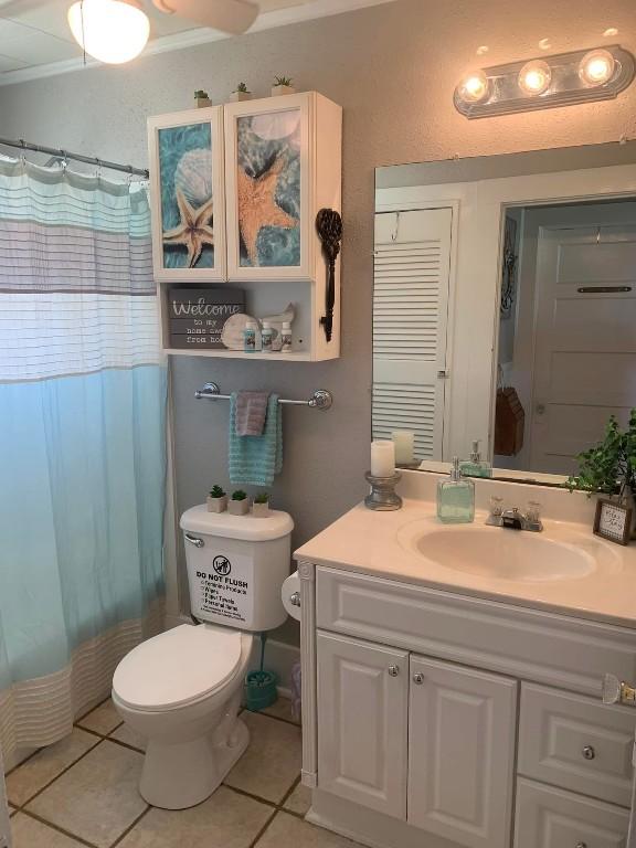 bathroom featuring crown molding, tile patterned flooring, vanity, and toilet