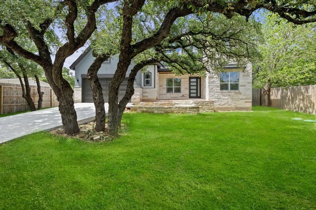 view of front facade with a front lawn and a garage