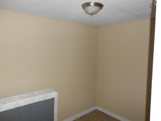 spare room featuring wood-type flooring