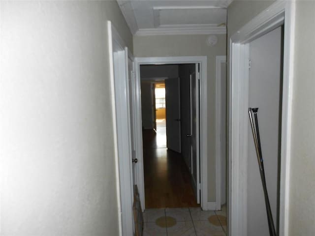 corridor featuring crown molding and light tile patterned flooring