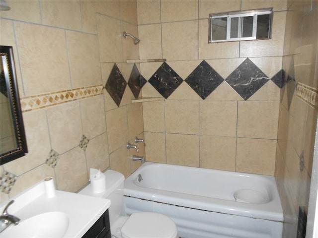 full bathroom featuring vanity, tiled shower / bath combo, and toilet