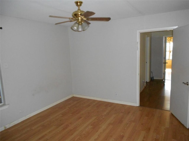 empty room with ceiling fan and hardwood / wood-style flooring