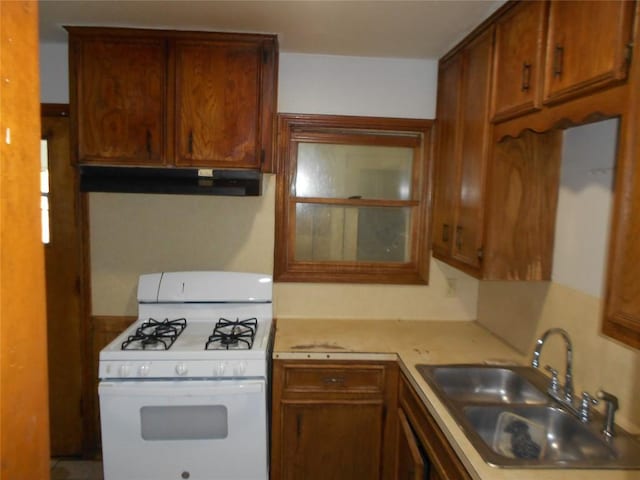 kitchen featuring white gas stove and sink