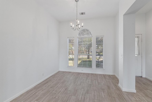 unfurnished dining area featuring a notable chandelier