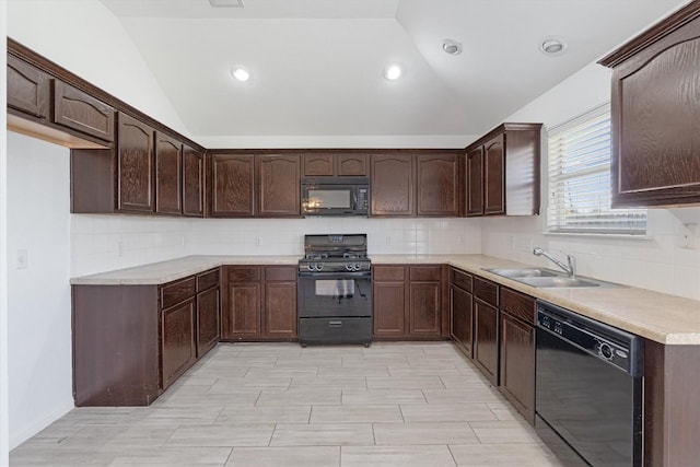 kitchen with dark brown cabinetry, black appliances, and lofted ceiling