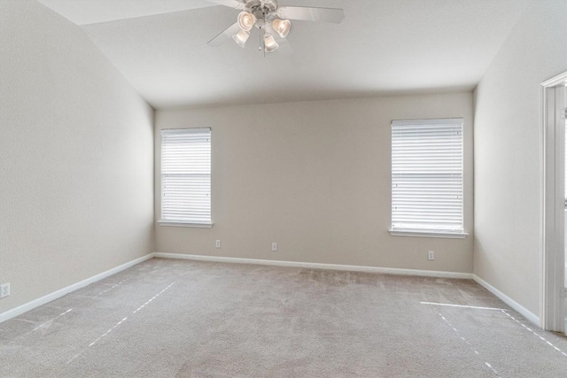 unfurnished room featuring light carpet, vaulted ceiling, and ceiling fan