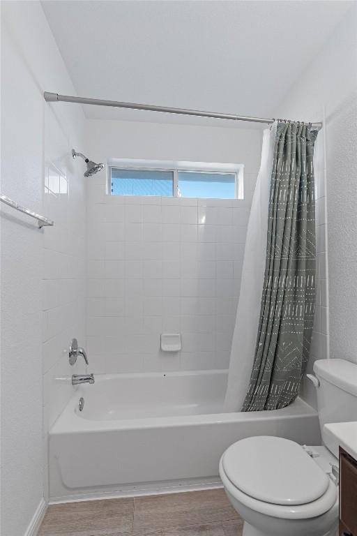 full bathroom featuring vanity, toilet, and shower / bathtub combination with curtain